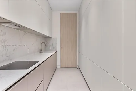 a kitchen with a sink and cabinets