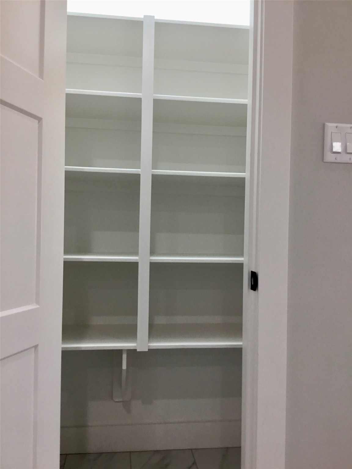 924 East 2nd Street Bellville, TX 77418 - Photo 13 of 38 a view of walk in closet with empty racks