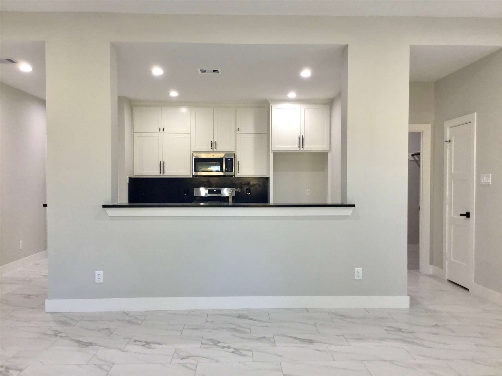 924 East 2nd Street Bellville, TX 77418 - Photo 14 of 38 a view of a kitchen with stainless steel appliances granite countertop a refrigerator a stove and a sink