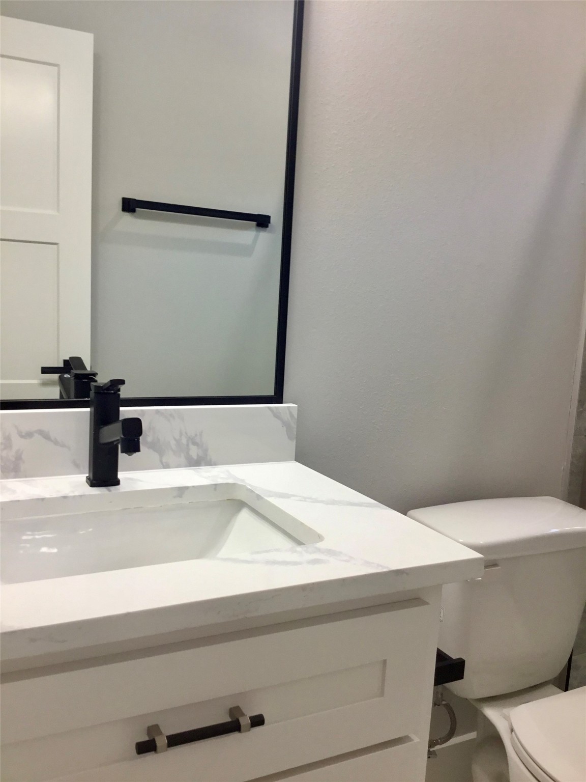 924 East 2nd Street Bellville, TX 77418 - Photo 21 of 38 a bathroom with a sink and a mirror