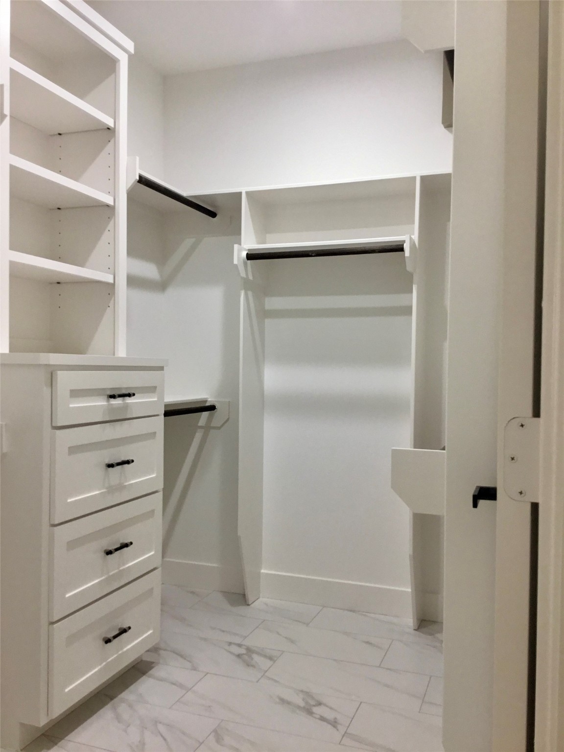 924 East 2nd Street Bellville, TX 77418 - Photo 27 of 38 a view of walk in closet with empty racks