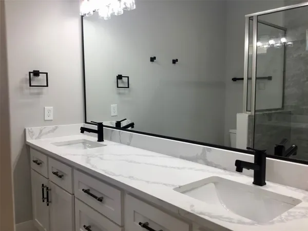 a bathroom with a glass door shower