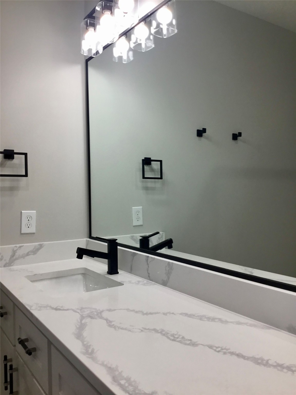 924 East 2nd Street Bellville, TX 77418 - Photo 34 of 38 a bathroom with a sink a light fixture and a wooden floor