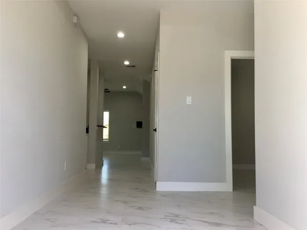 a view of a hallway with wooden shelves