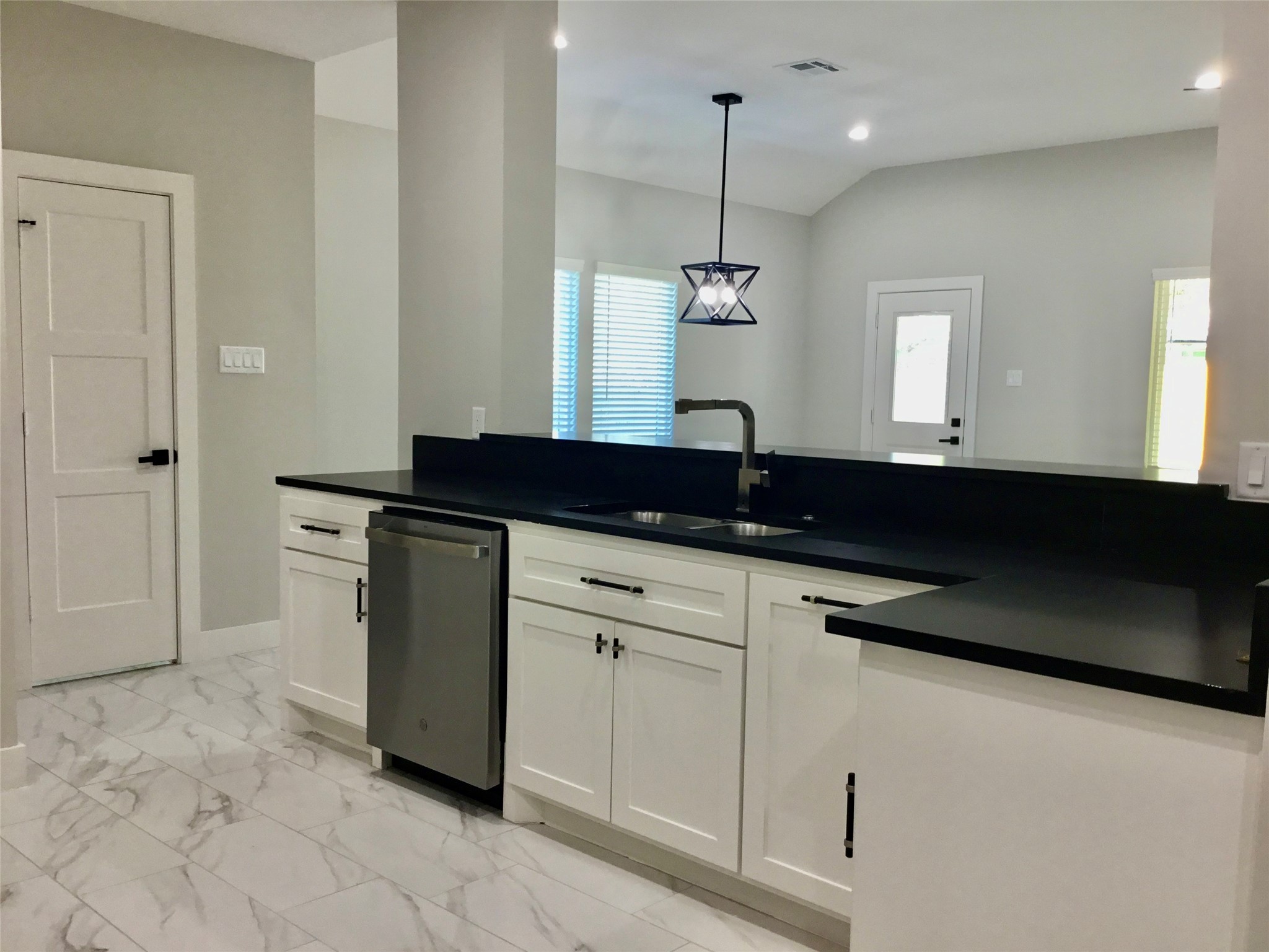 924 East 2nd Street Bellville, TX 77418 - Photo 10 of 38 a kitchen with a sink and white cabinets