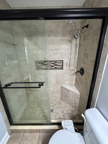 a bathroom with a toilet and a shower