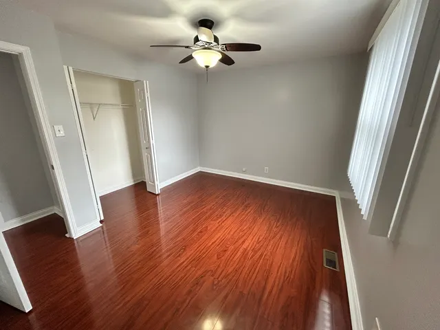 wooden floor in an empty room with a window