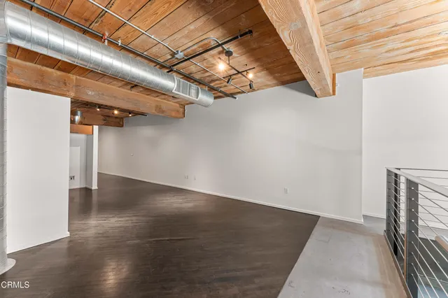 a view of a room with wooden floor