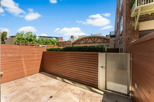 a view of balcony with wooden floor and fence