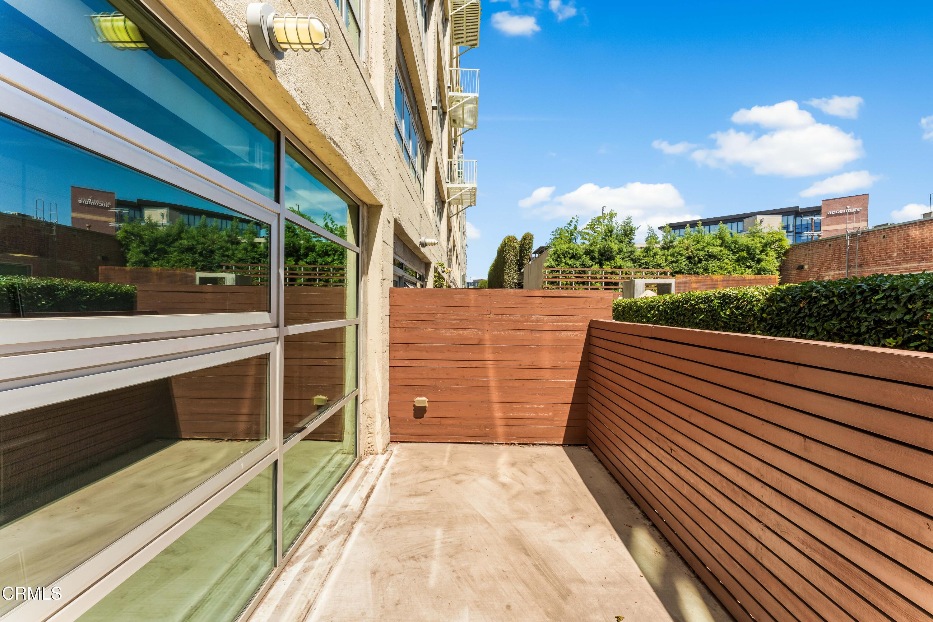 530 South Hewitt Street, Unit 130 Los Angeles, CA 90013 - Photo 26 of 53 a view of balcony with wooden floor and fence
