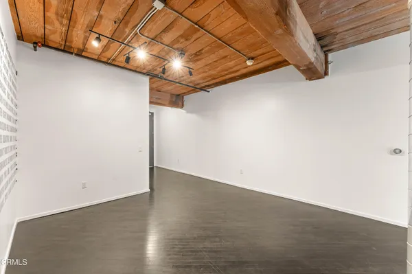 a view of a room with wooden floor