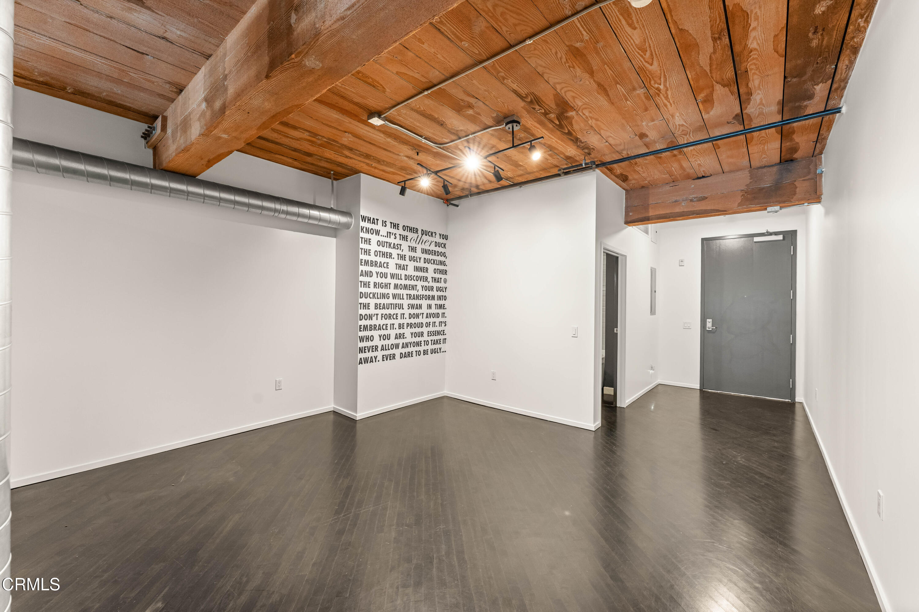 530 South Hewitt Street, Unit 130 Los Angeles, CA 90013 - Photo 6 of 53 a view of an empty room with wooden floor and a window