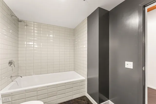 a bathroom with a bathtub and shower