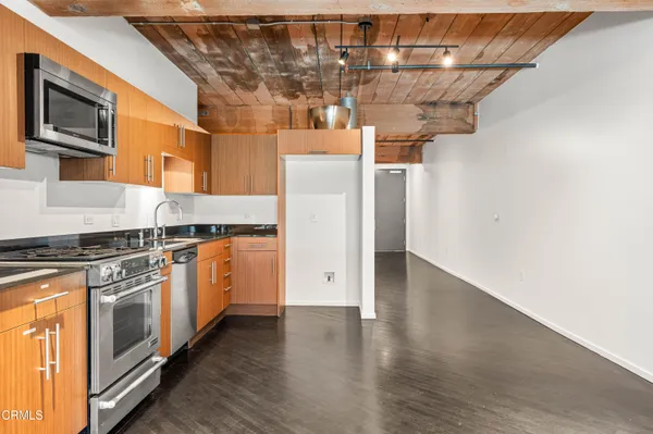 a kitchen with stainless steel appliances granite countertop a stove and a refrigerator