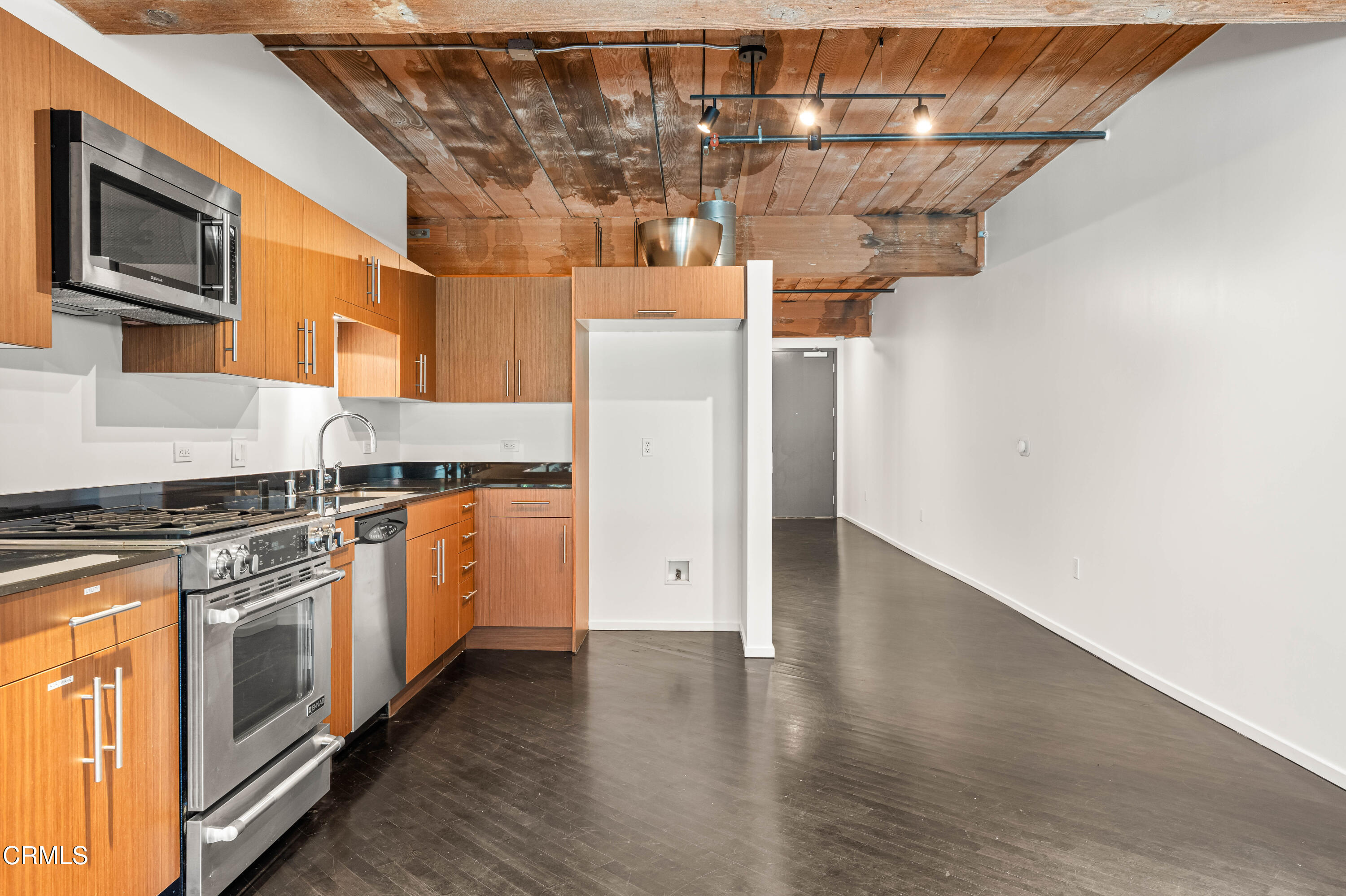 530 South Hewitt Street, Unit 130 Los Angeles, CA 90013 - Photo 10 of 53 a kitchen with stainless steel appliances granite countertop a stove and a refrigerator