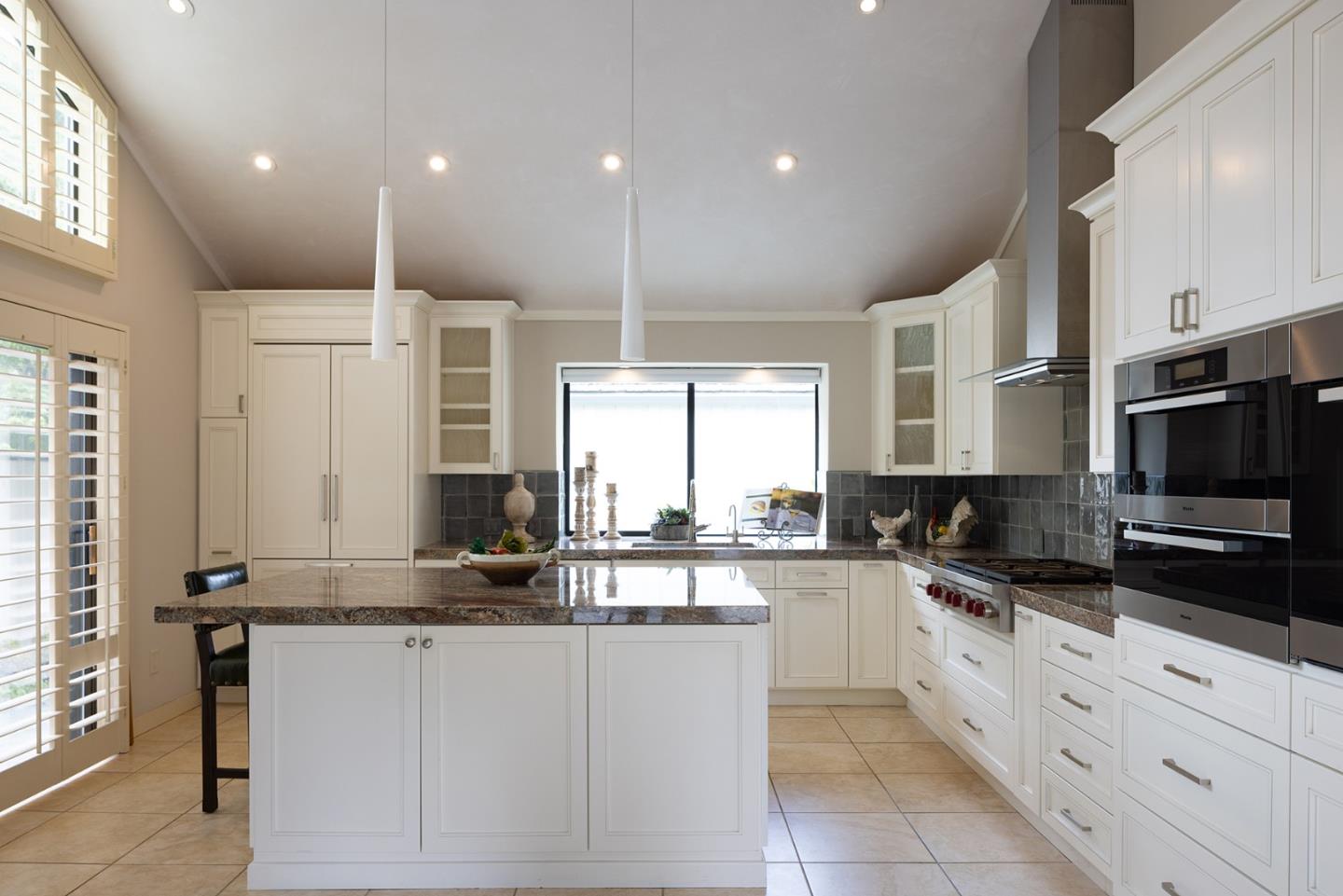 9621 Homestead Road Carmel, CA 93923 - Photo 14 of 30 a kitchen with stainless steel appliances kitchen island granite countertop a sink and cabinets