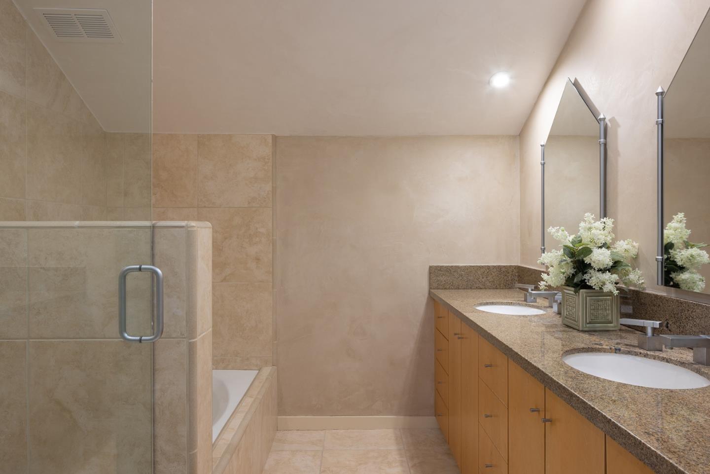 9621 Homestead Road Carmel, CA 93923 - Photo 21 of 30 a bathroom with a granite countertop sink and a mirror