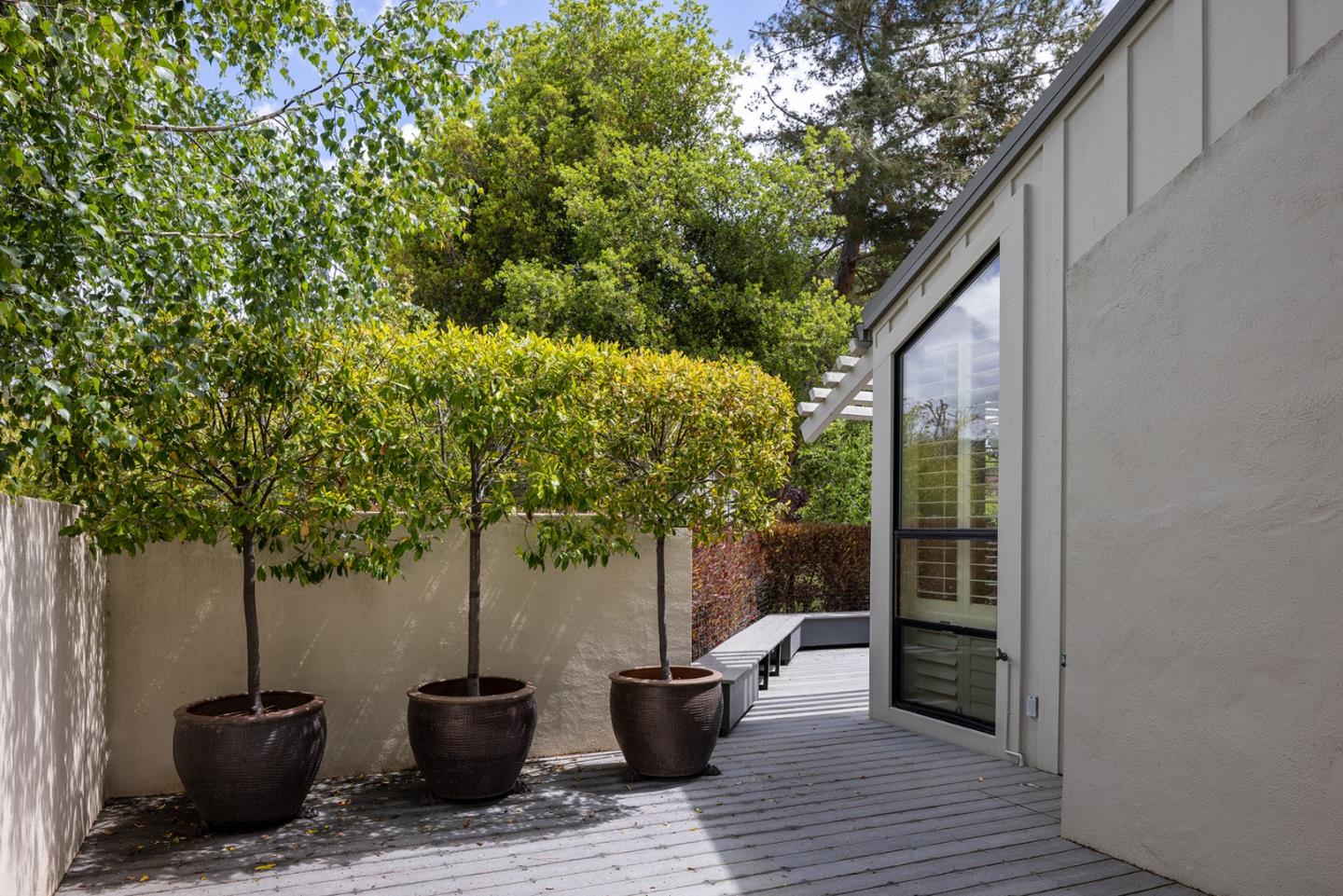 9621 Homestead Road Carmel, CA 93923 - Photo 25 of 30 a view of a patio with table and chairs and potted plants