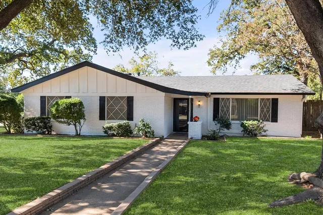 a front view of a house with a garden and porch