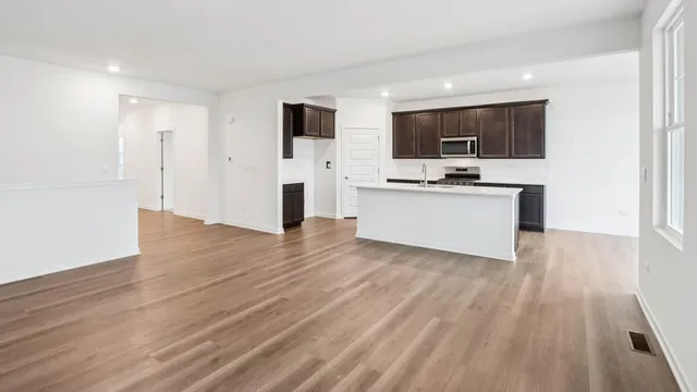 a view of a kitchen with a sink and a refrigerator