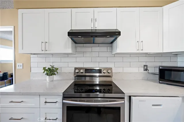 a stove top oven sitting inside of a kitchen