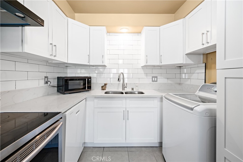 2018 Las Vegas Avenue, Unit 18 Pomona, CA 91767 - Photo 13 of 23 a kitchen with white cabinets and white appliances