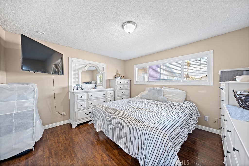 2018 Las Vegas Avenue, Unit 18 Pomona, CA 91767 - Photo 16 of 23 a bedroom with a bed and a flat screen tv