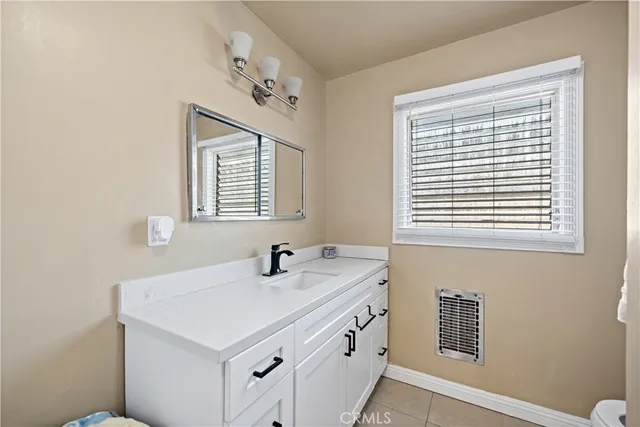 a bathroom with a sink and a window