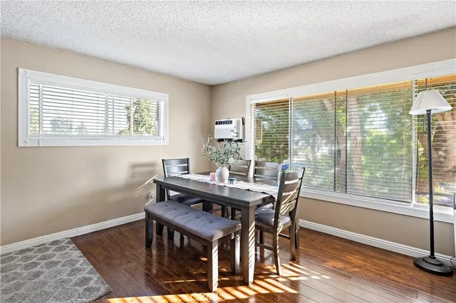 a dining room with furniture and wooden floor