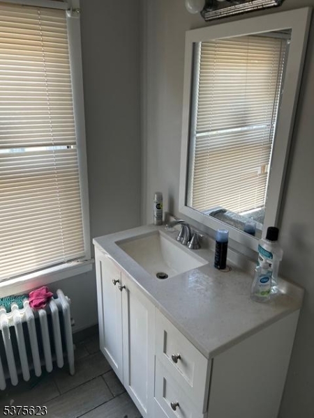 21 2nd Street Somerville, NJ 08876 - Photo 12 of 15 a bathroom with a sink and a mirror