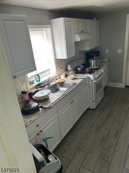 21 2nd Street Somerville, NJ 08876 - Photo 5 of 15 a kitchen with a sink a stove and cabinets