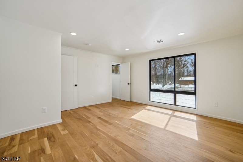 156 Park Road Parsippany, NJ 07054 - Photo 29 of 44 a view of an empty room with wooden floor and windows