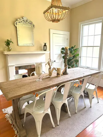 a dining room with furniture and window