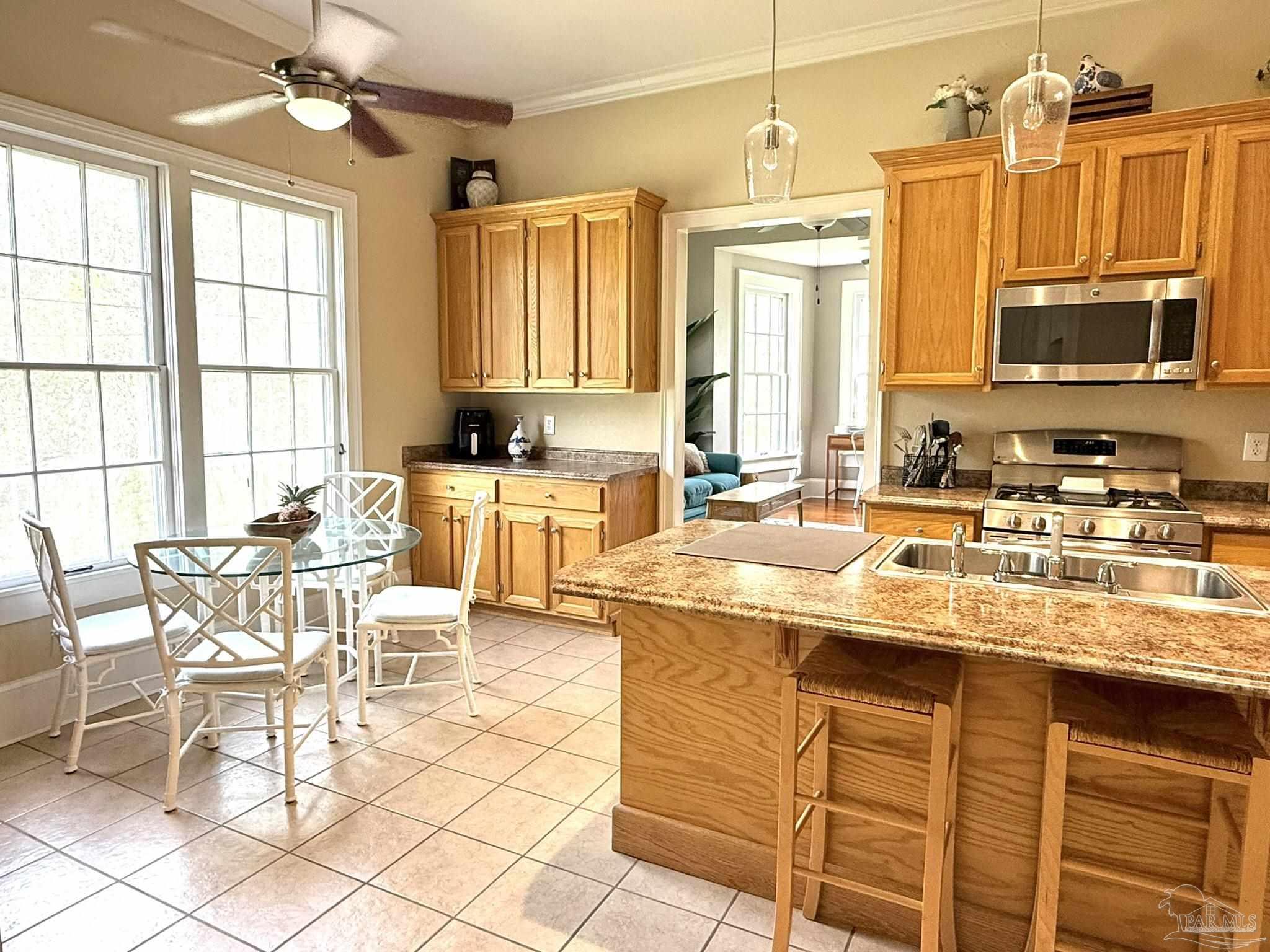 6855 Pine Street Milton, FL 32570 - Photo 13 of 31 a kitchen with stainless steel appliances granite countertop a sink and a refrigerator