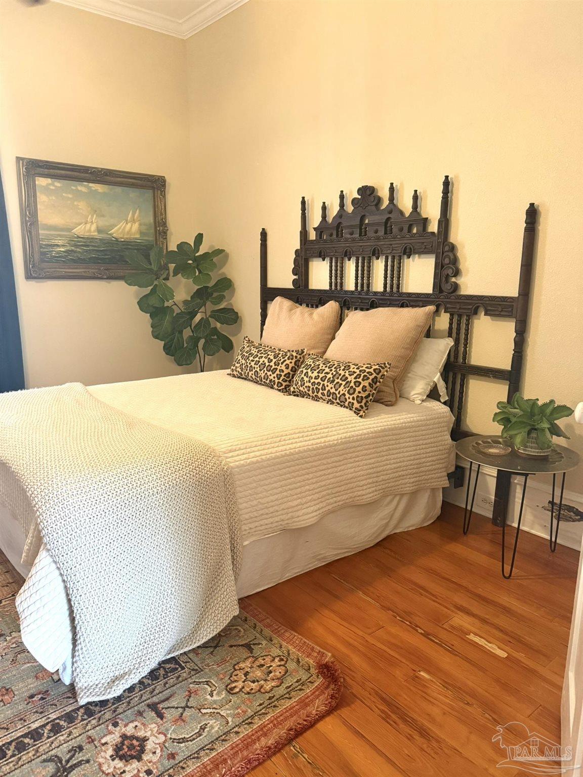 6855 Pine Street Milton, FL 32570 - Photo 15 of 31 a bed sitting in a bedroom next to a large window