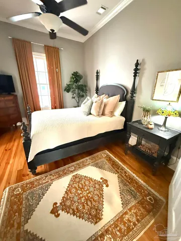 a bed sitting in a bedroom next to a window