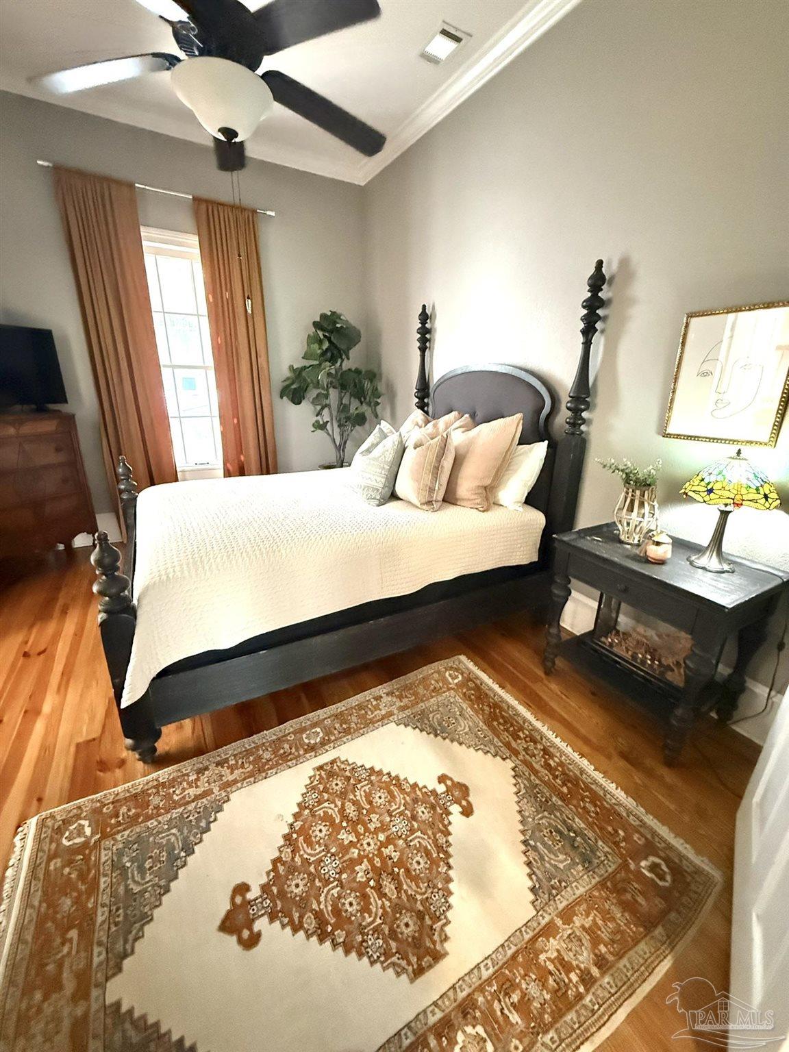 6855 Pine Street Milton, FL 32570 - Photo 19 of 31 a bed sitting in a bedroom next to a window