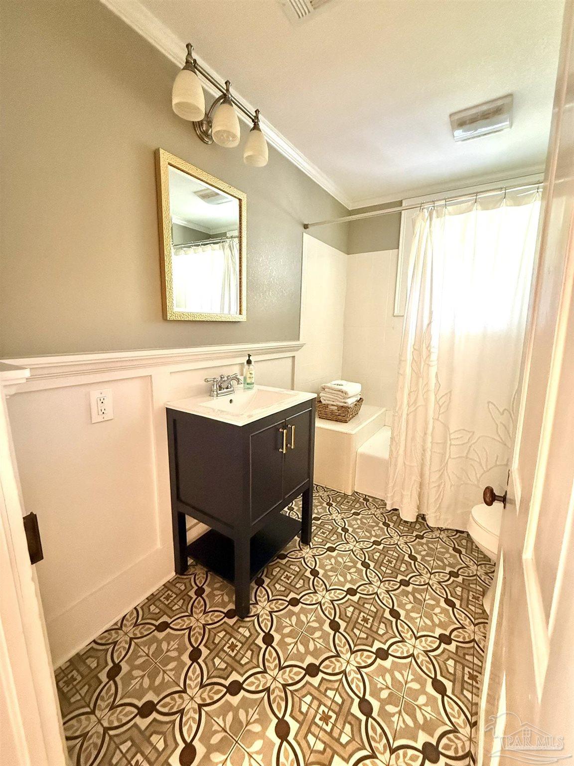 6855 Pine Street Milton, FL 32570 - Photo 24 of 31 a bathroom with a sink a toilet and mirror
