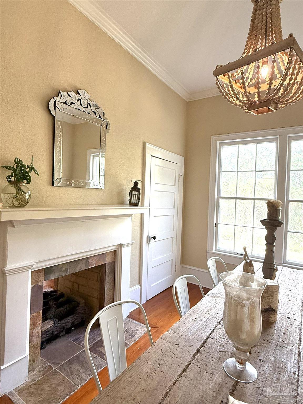 6855 Pine Street Milton, FL 32570 - Photo 25 of 31 a living room with furniture a window and a fireplace
