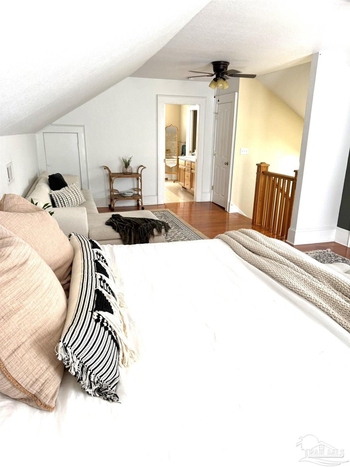 6855 Pine Street Milton, FL 32570 - Photo 28 of 31 a bedroom with a bed and wooden floor