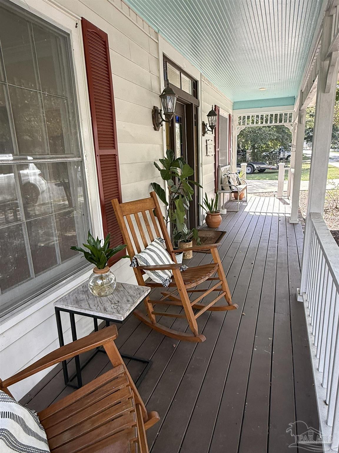 6855 Pine Street Milton, FL 32570 - Photo 5 of 31 a view of balcony with chairs and wooden floor