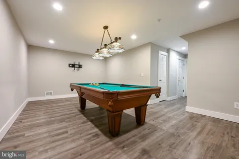a room with wooden floor and furniture
