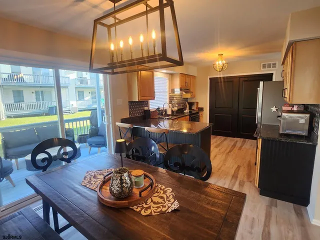a kitchen with granite countertop a stove and refrigerator