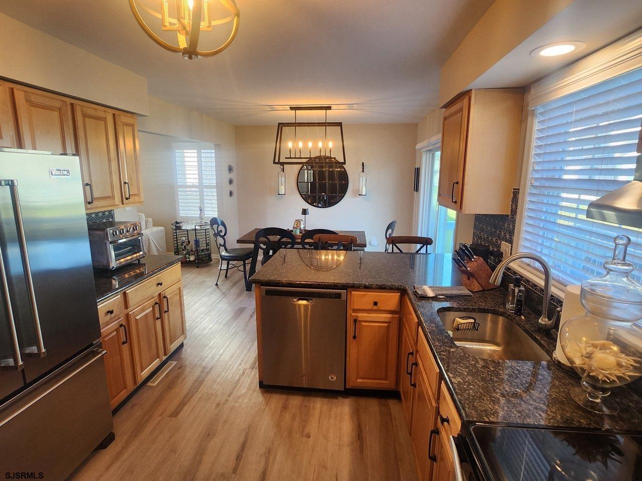 330 Gull Cove Brigantine, NJ 08203 - Photo 13 of 34 a kitchen with stainless steel appliances granite countertop a stove a sink dishwasher and a refrigerator