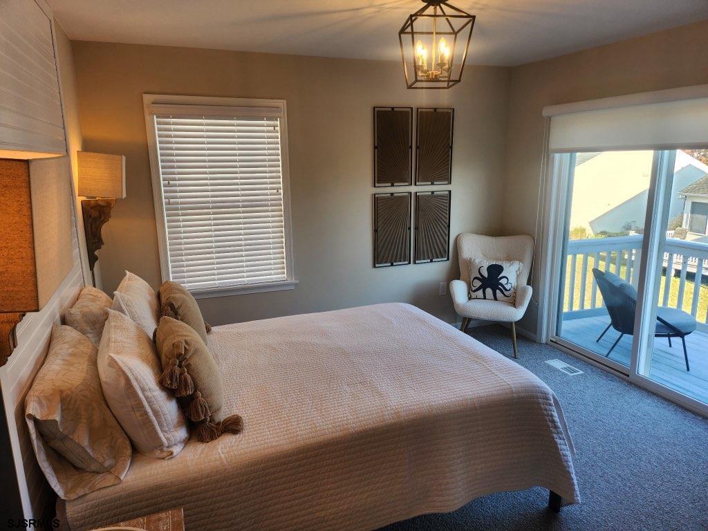 330 Gull Cove Brigantine, NJ 08203 - Photo 14 of 34 a bedroom with a bed and a table lamp