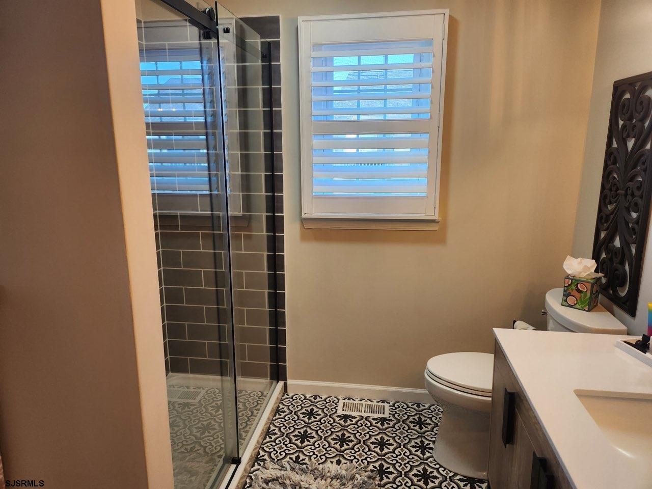 330 Gull Cove Brigantine, NJ 08203 - Photo 16 of 34 a bathroom with a sink a toilet and shower