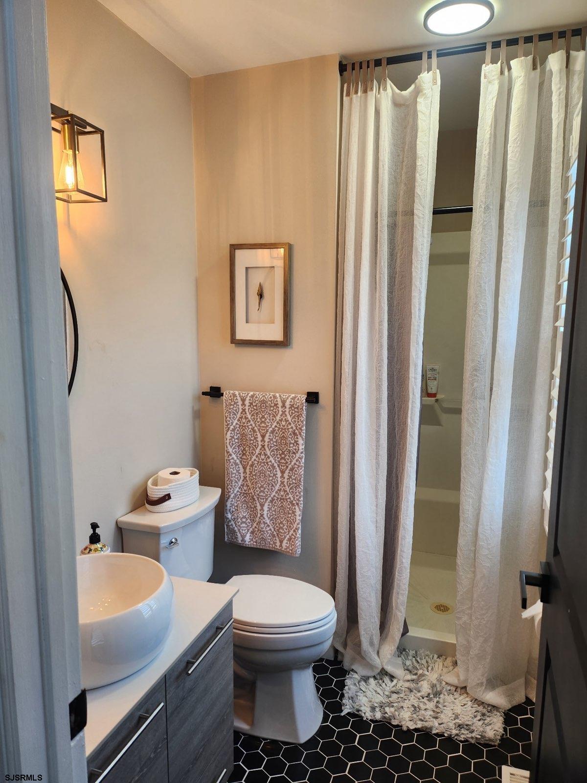 330 Gull Cove Brigantine, NJ 08203 - Photo 19 of 34 a bathroom with a toilet sink and shower curtain