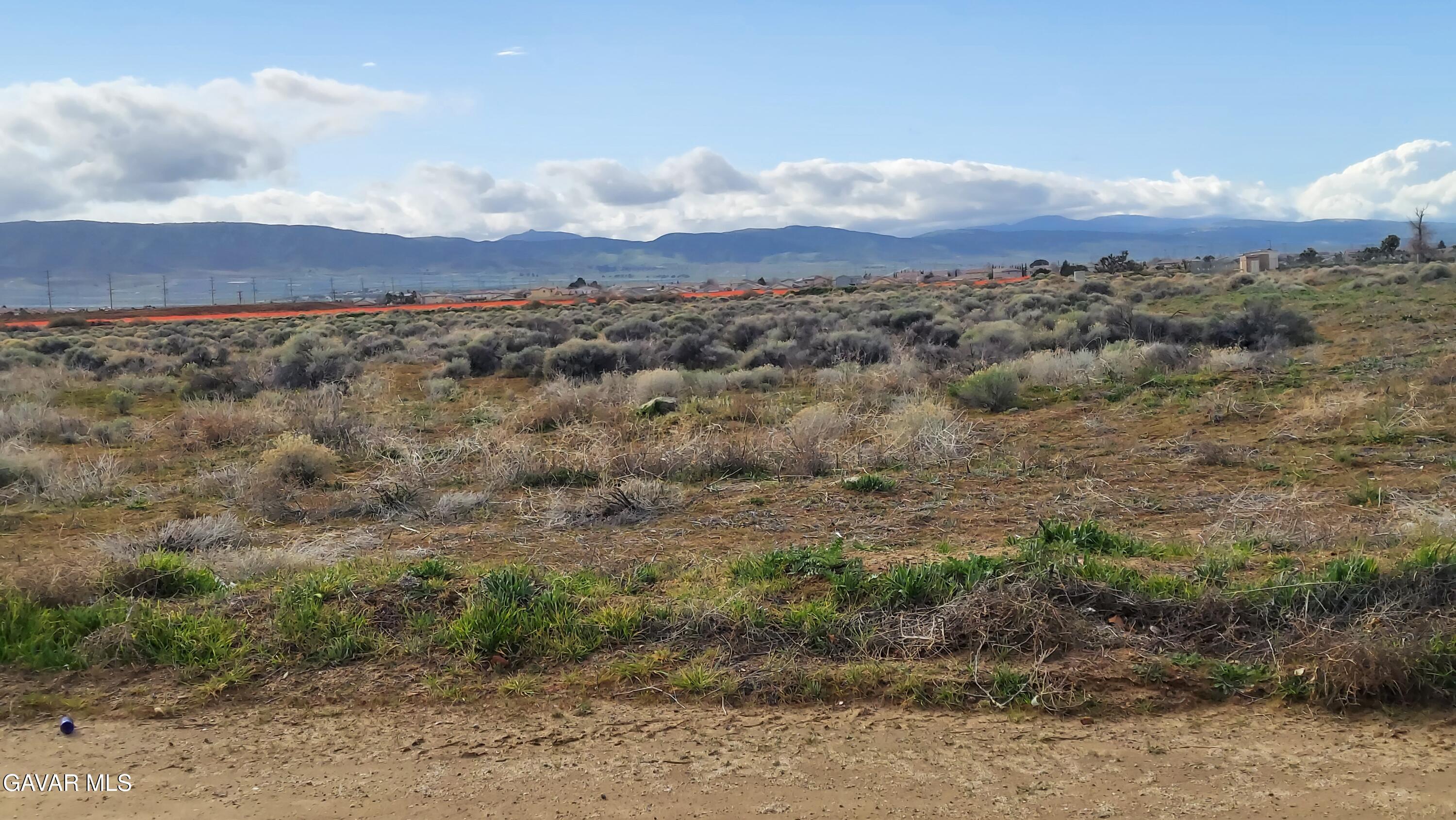 a view of a large mountain with mountains in the background