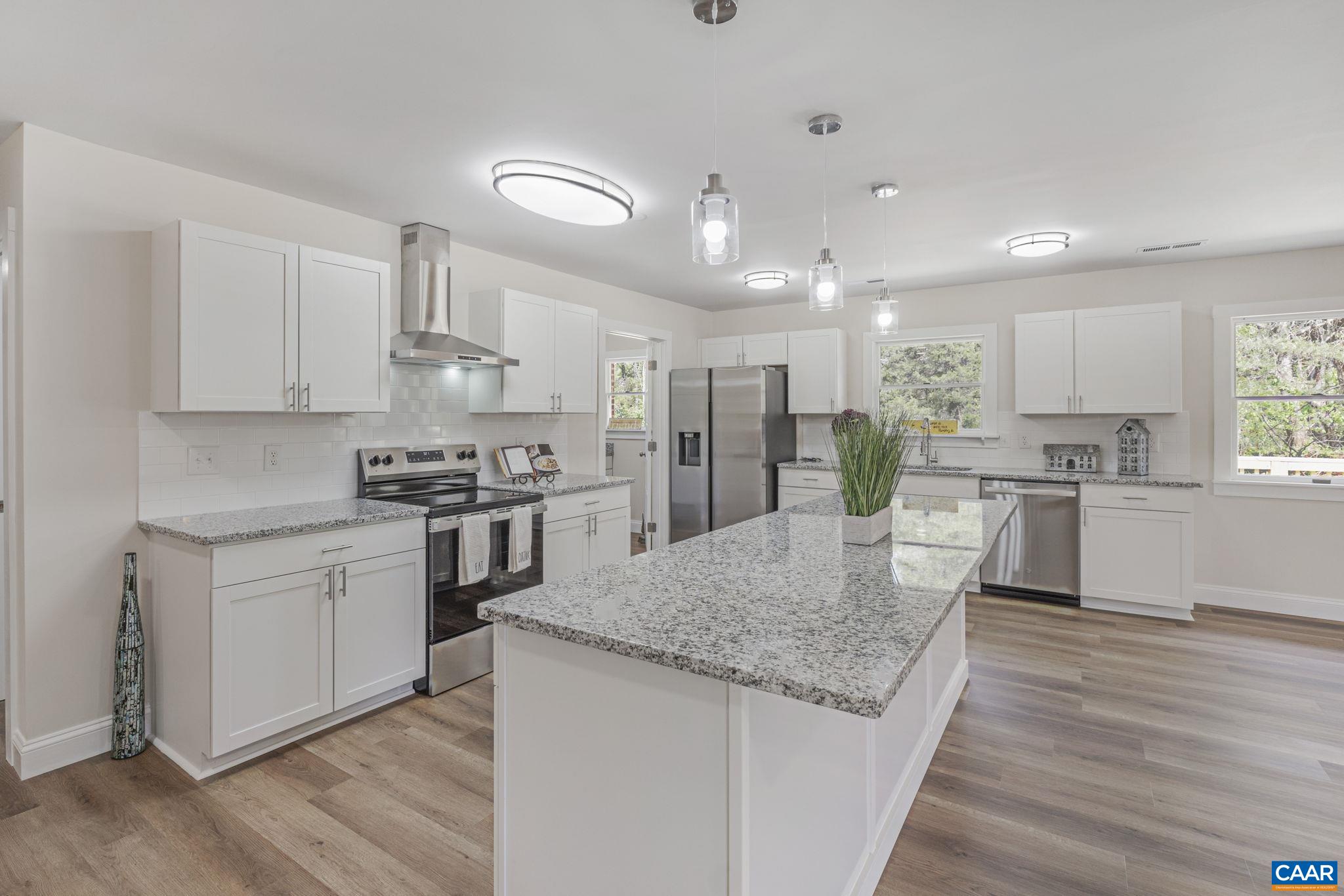 115 Montview Drive Ruckersville, VA 22968 - Photo 12 of 55 a kitchen with stainless steel appliances granite countertop a sink stove and refrigerator