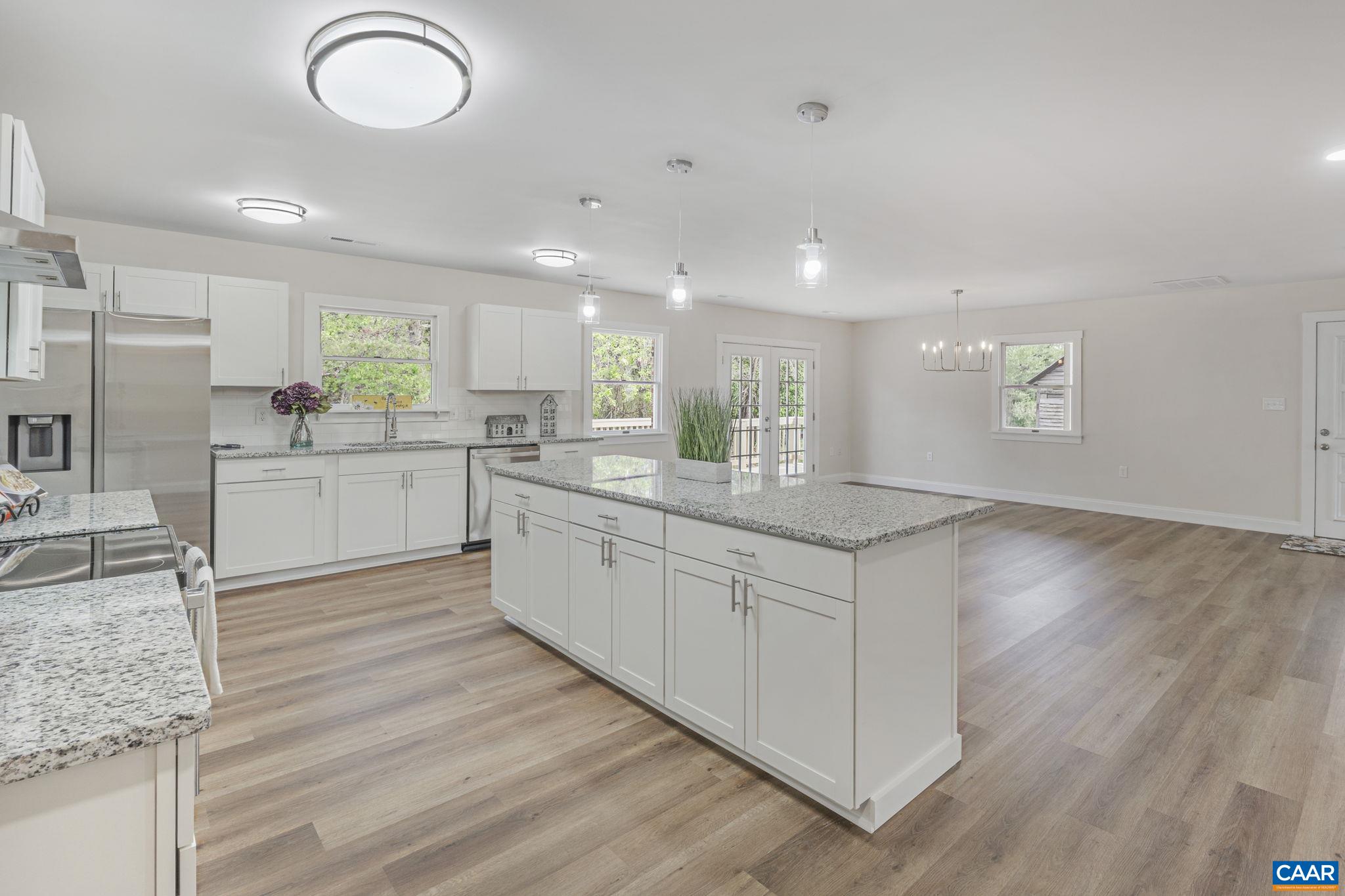 115 Montview Drive Ruckersville, VA 22968 - Photo 13 of 55 a large kitchen with stainless steel appliances granite countertop a sink dishwasher a stove with wooden cabinets and floors